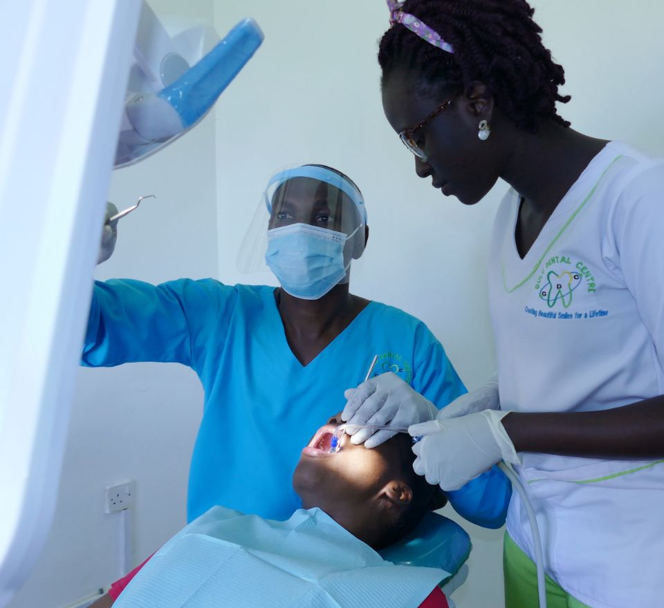 Dentist smiling with a patient at Gulu Dental Centre